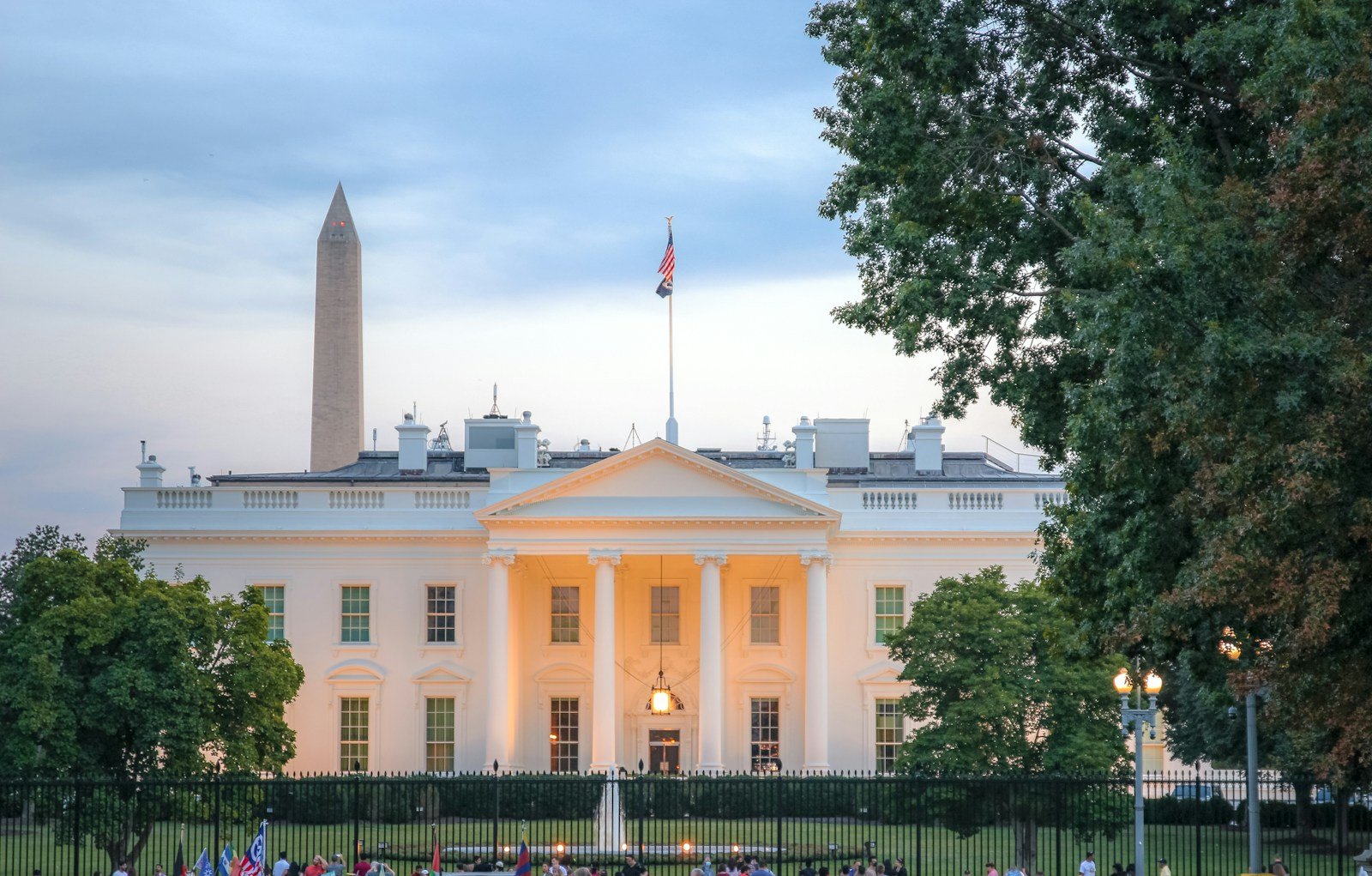 a large white building with a flag on top of it