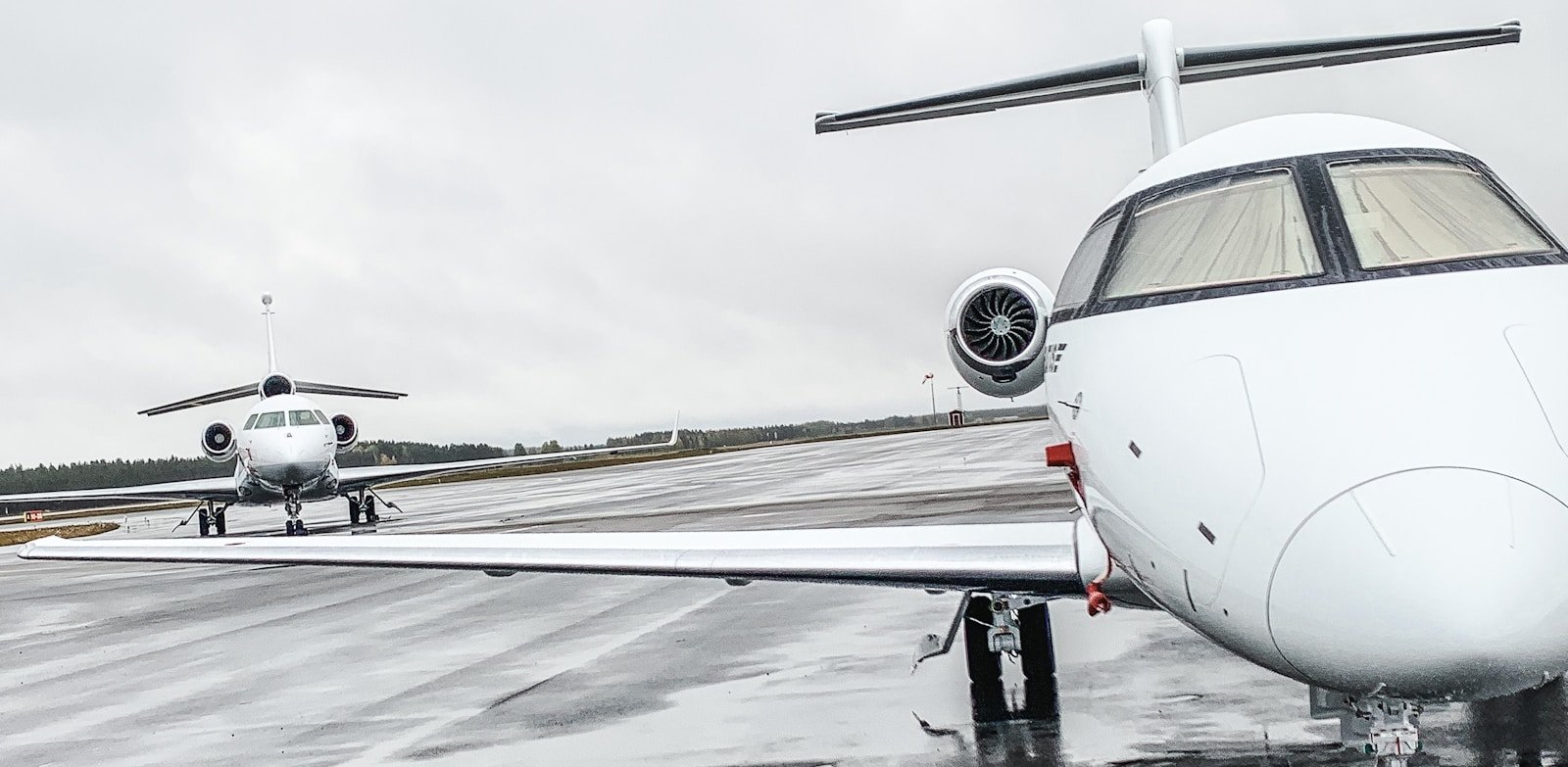 a small white airplane sitting on top of an airport runway