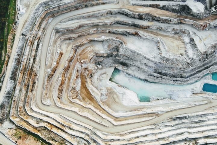 an aerial view of a quarry with a blue pool