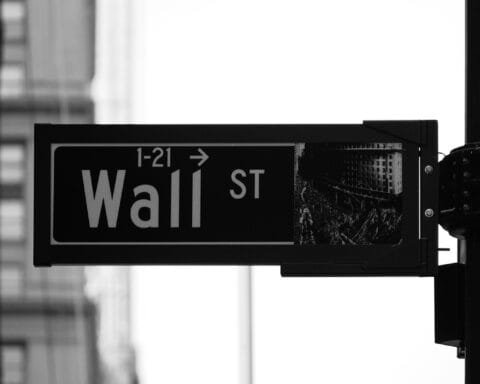 grayscale photo of Wall St. signage