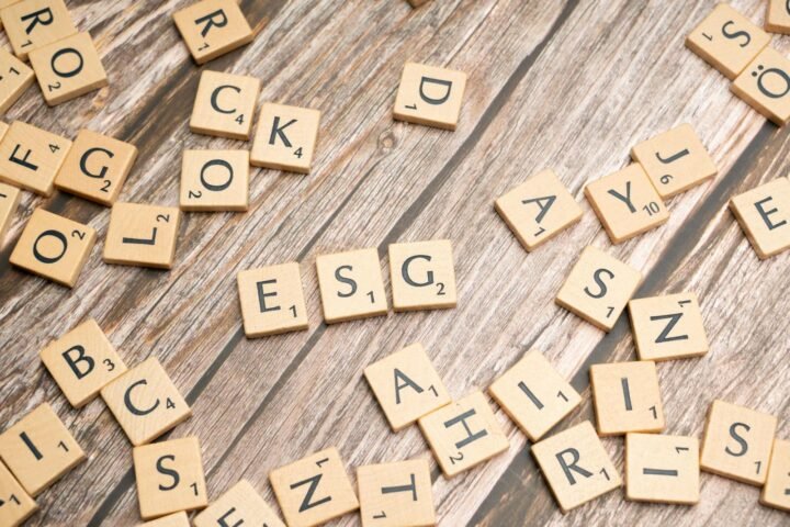 Scrabble tiles on a wooden table with the word rock