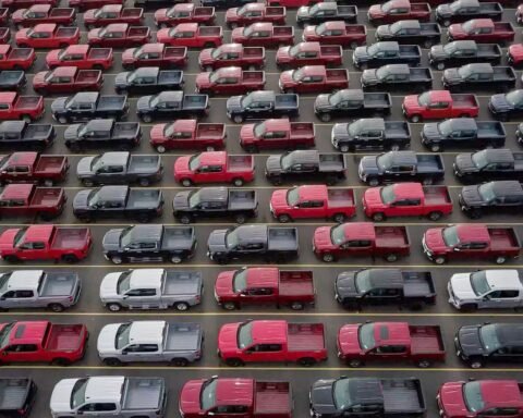 red and black cars on parking lot during daytime