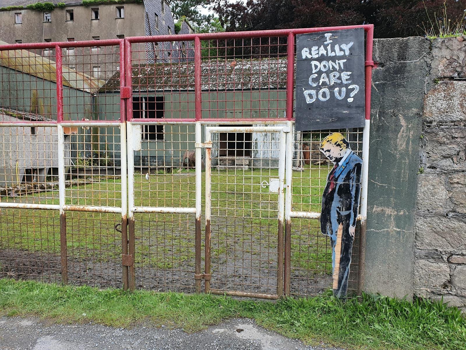 Donald Trump Likeness with a Slogan on an Abandoned Fence 