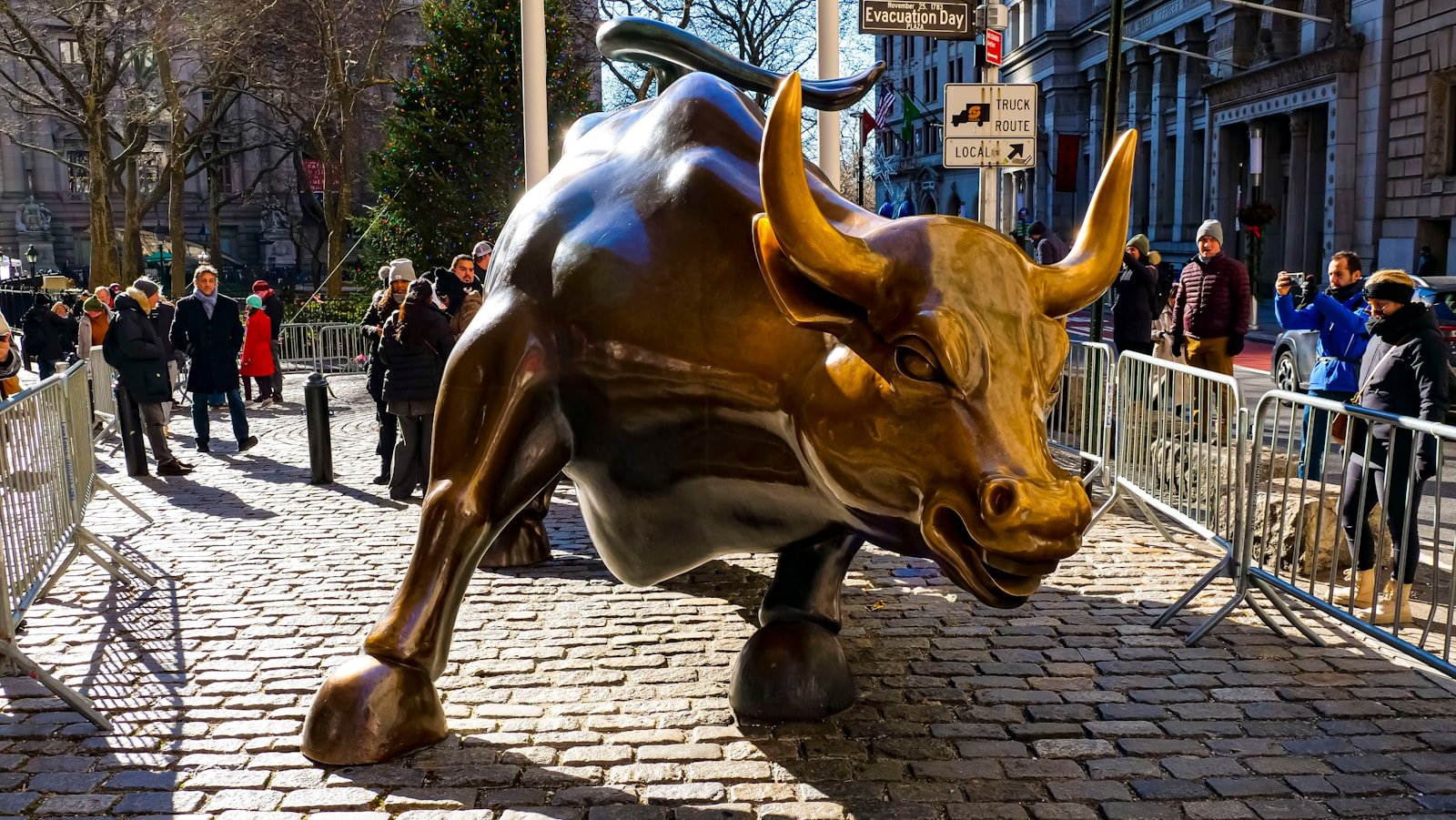 a statue of a bull on a brick street