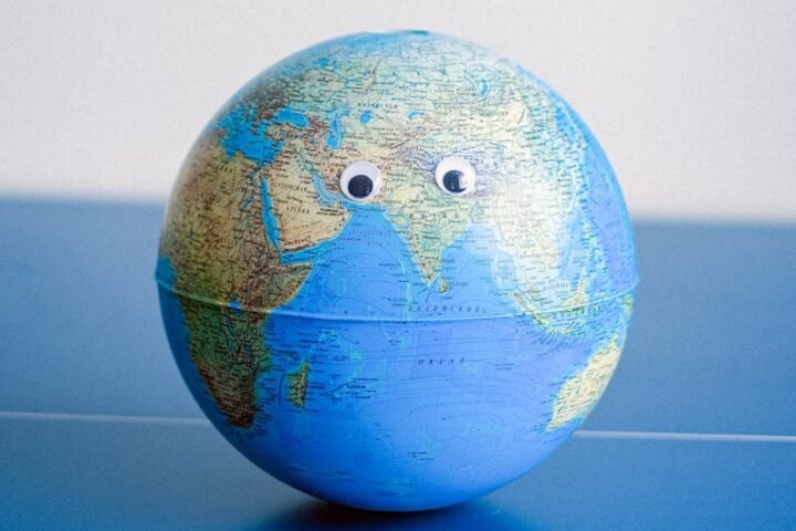 Sphere shaped miniature of Earth with googly eyes