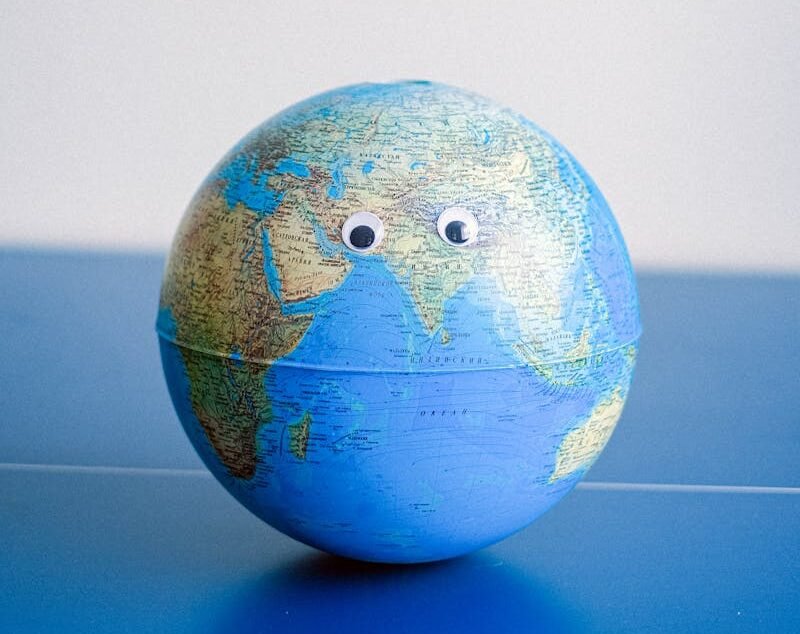 Sphere shaped miniature of Earth with googly eyes