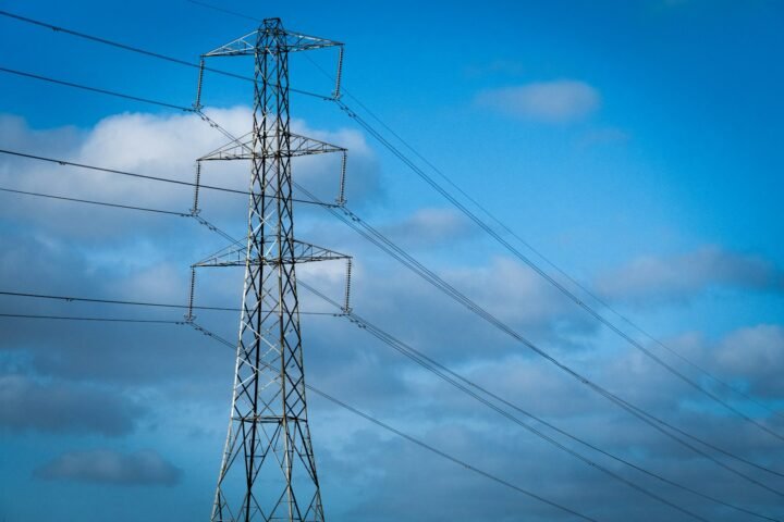 a high voltage power line against a blue sky