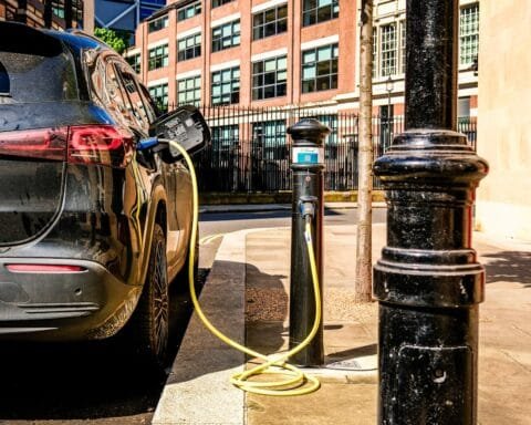 an electric car plugged in to a charging station