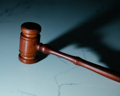 a wooden judge's hammer sitting on top of a table
