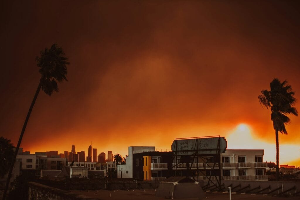 A large plume of smoke is seen over a city