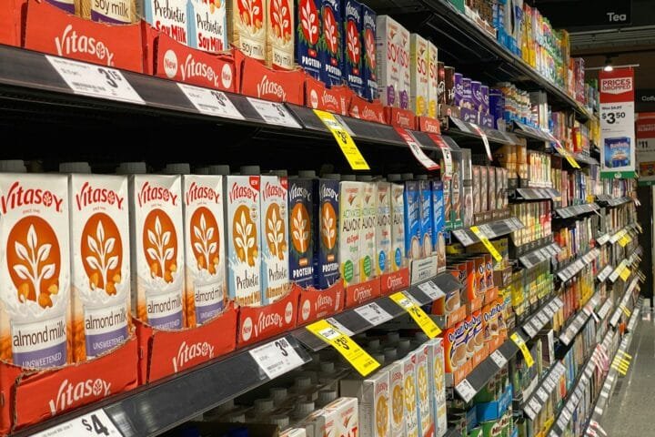red and white labeled plastic bottle on shelf