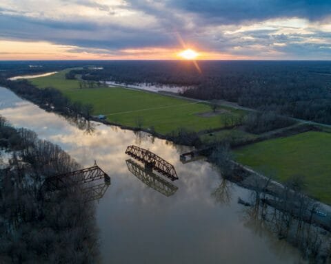 an aerial view of a river and a bridge