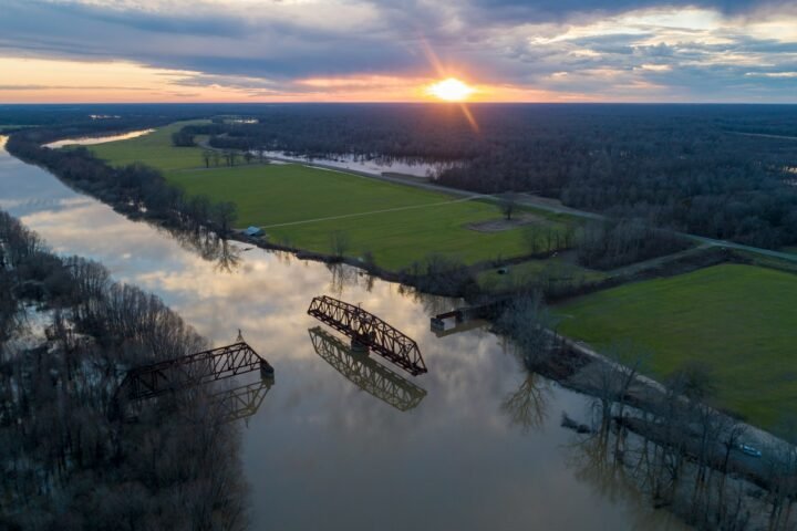 an aerial view of a river and a bridge